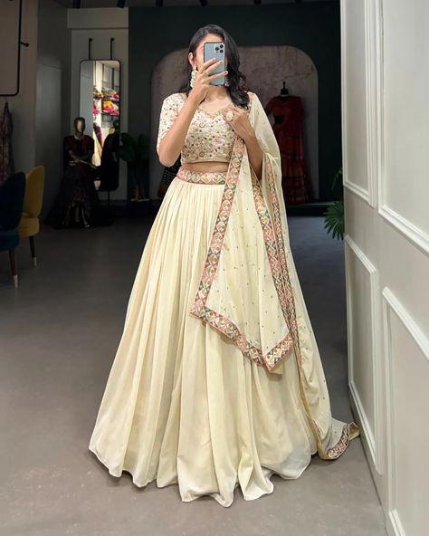 "Make a mesmerizing statement in our off-white lehenga choli! 🌷✨ Exquisite embroidery, shimmering sequins, and unparalleled elegance. Capture hearts and steal the spotlight effortlessly! #weareffortlessly #LehengaCholiLove #OffWhiteElegance #EmbroideredPerfection #SequinSparkle #FestiveFashion #EthnicChic #WeddingWear #LehengaGoals" ▪️Lehenga(Stitched) Lehenga Fabric : Georgette Lehenga work : Sequins and Thread Embroidery Work With Lace Border Lehenga Waist : SUPPORTED UP TO 42 Lehenga Cl... Lehnga Designs Indian Weddings, Wedding Chaniya Choli, Zip Stitching, White Lehenga Choli, Engagement Lehenga, Lehenga Choli Designs, Lehenga Saree Design, White Lehenga, Georgette Lehenga