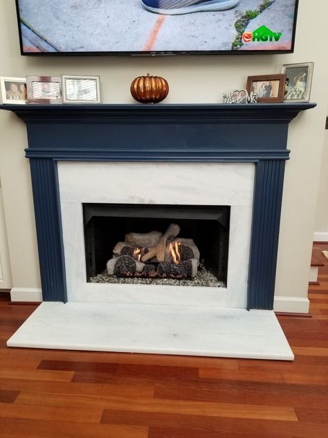 I painted fireplace mantel and place marble with hints of  gray and blue. Replaced logs with Aspen logs....love the new look!@ Painted Blue Fireplace Mantels, Navy And White Fireplace, Blue Gray Fireplace Mantle, Navy Blue Fireplace Mantel, Navy Fireplace Mantel, Navy Blue Mantle, Blue Mantle Fireplace, Blue Fireplace Mantel, Navy Mantle