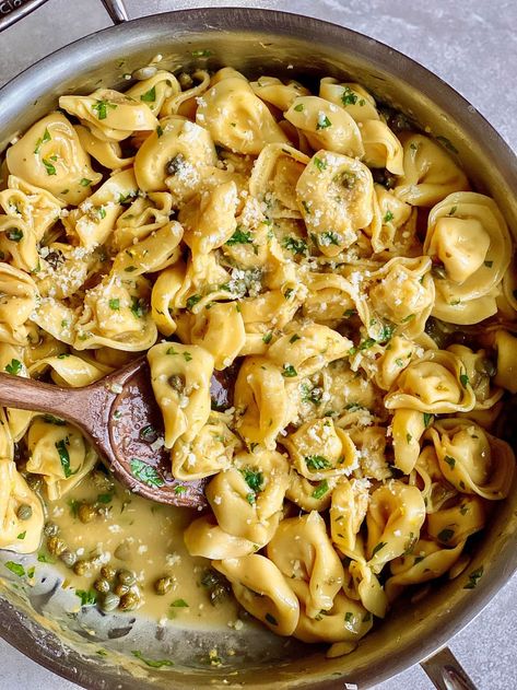 tortellini pasta with capers, parsley, and parmesan in skillet with wooden spoon Lemon Butter Tortellini, Tortellini Piccata, Tortellini Vegetarian, Butter Tortellini, Lemon Butter Sauce Pasta, Pasta With Capers, Butter Sauce For Pasta, Piccata Recipe, Pastas Recipes