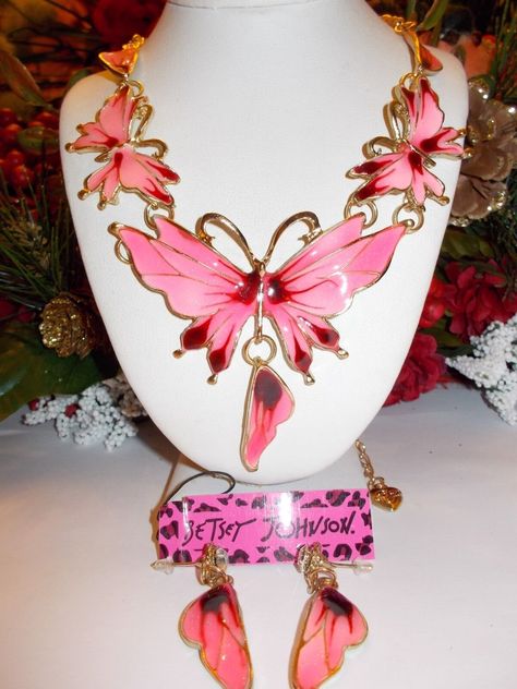 BETSEY JOHNSON PINK BUTTERFLY WINGS CRYSTAL AND ENAMEL NECKLACE & EARRINGS PRODUCT SPECIFICATIONS Condition: New with tags Modified Item: No Country/Region of Manufacture: China Style: FRONTAL CHAIN NECKLACE Base Metal: Alloy Length (inches): 18" + 3" EXTENDER = 21" Material: Enamel Theme: Beauty PENDANT SIZE: 6.1" X 2.4" Locket Type: Charm Color: Pink Main Stone: Crystal Pendant Shape: BUTTERFLIES Metal: Yellow Gold Plated Brand: Betsey Johnson LOVELY PINK WITH MAROON CENTERS CHAINED LINKED BUTTERFLIES INLAID WITH CRYSTAL AND FINISHED IN  ENAMEL YELLOW GOLD PLATED FRONTAL BIB NECKLACE AND EARRINGS DESIGN BY BETSEY JOHNSON. THE NECKLACE COMES WITH A MATCHING PAIR OF EARRINGS. THE TOTAL LENGTH IS 21 INCHES WITH EXTENDER.  THE PENDANT PORTION MEASURES APPROXIMATELY 6.1 INCHES IN WIDTH AND IS Pink Butterfly Wings, Dope Jewelry Accessories, Makeup Accesories, Betsey Johnson Necklace, Pink Jewels, Fairy Artwork, China Style, Dope Jewelry, Enamel Necklaces