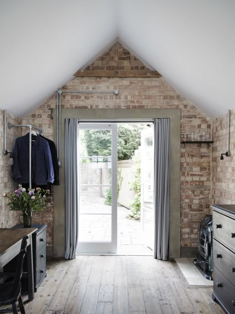 In the back of the garage, new curtained French doors serve as the entrance: A short walk across the terrace leads to the main house. The concrete door surround is a detail Lewis also introduced around the bathroom door. Garage Bedroom Conversion, Garage To Living Space, Garage Floor Paint, Small Bedroom Remodel, Garage Room, Garage Bedroom, Garage Renovation, Interior Design London, Garage Remodel