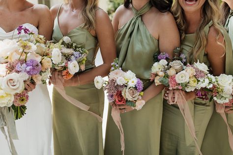 Bride in a modern, white wedding gown and bridesmaids in green dresses with their colourful bouquets. Bouquets For Green Bridesmaid Dresses, Colourful Bridesmaid Bouquet, Whimsical Summer Wedding, Modern White Wedding, 2026 Wedding, Olive Green Bridesmaid Dresses, Sage Green Wedding Colors, J Photo, Bridesmaids Ideas