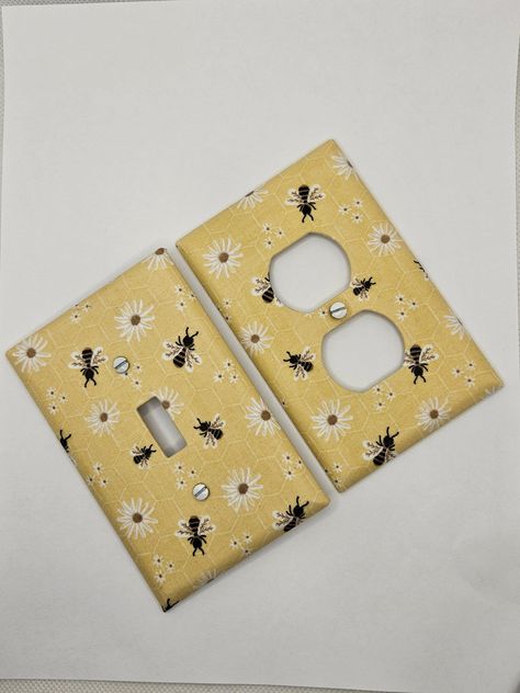 Bumble Bee & Flowers Light Switch and Outlet Covers.  Please view chart in the photos before ordering to ensure you are ordering the correct plate type.  All plates are individually wrapped and come with white head screws. The super cute Bumble Bee Light Switch Covers are the perfect accent to bring a room together.  Perfect for nurseries! These plates are mid-sized, other sizes available upon request.  Orders ship within 3-5 business days. Tracking will be available via USPS.  FREE SHIPPING on Bumble Bee Room Decor, Nursery Bumble Bee, Bug Themed Bedroom, Bee Themed Nursery Baby Rooms, Bee Theme Room, Bee Bedroom Theme, Bee Themed Nursery, Bumble Bee Kitchen, Bee Room Decor