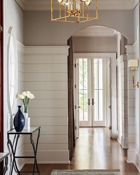 McDonald Architects on Instagram: “Simple touches—shiplap walls and a curved doorway—amplify this entryway. French doors at the end of the hall brighten the space and add…” Low Country Lighting Fixtures, Lowcountry Style Home, Low Country Interiors, Low Country Homes Interior, Low Country Interior Design, Low Country Cottage, Judges Paneling, Shingle Style Architecture, Low Country Homes