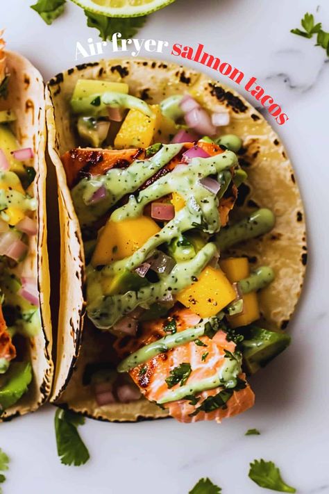 Love quick dinners? You need these air fryer salmon tacos! Perfectly cooked salmon, zesty mango salsa, and so easy. Salmon Tacos Air Fryer, Air Fryer Salmon Tacos, Salmon Tacos With Mango Salsa, Mango Tacos, Salmon Fish Tacos, Salmon Mango, Salmon Tacos Recipe, Tacos With Mango Salsa, Cooked Salmon