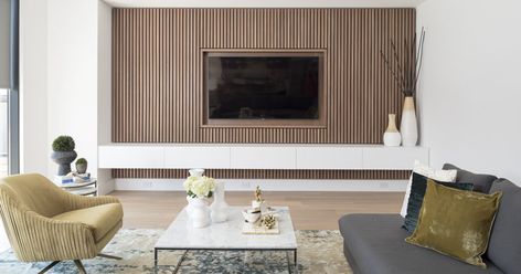 RZ INTERIORS have designed a contemporary and minimal wood slat accent wall for this family room, that would help to achieve a simplified sense of calm. Timber Tv Feature Wall, Timber Slat Tv Wall, Timber Tv Wall, Tv Wall Wood Slats, Timber Feature Wall Living, Timber Slat Feature Wall, Tv Feature Wall With Storage, Tv Surround, Room Pinterest