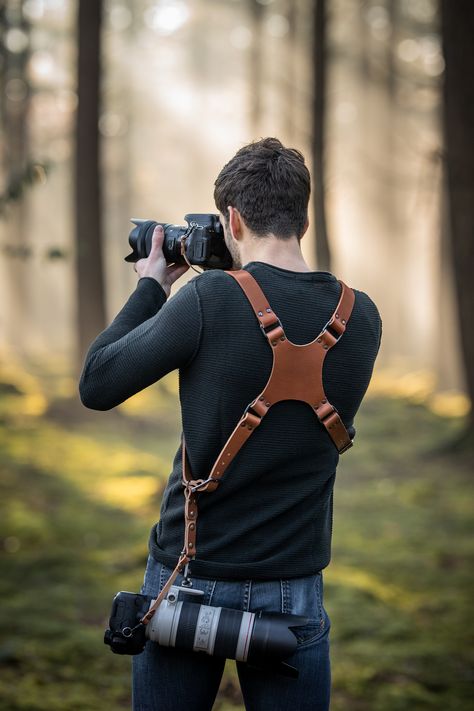 Handmade leather camera harness, photographer with sunset using a dual camera holster Leather handmade Camera Strap, Camera Harness, personalized dual camera holster, custom leather camera harness, Accessory for professional photography, Camera neck and shoulder straps, Quality leather harnesses and straps for photographers, Leather camera neck and shoulder straps, photography accessories, personalized with your logo or personal design Camera Holster, Professional Photography Camera, Camera Harness, Diy Leather Projects, Photography Accessories, Leather Harness, Camera Strap, Photography Camera, Leather Projects