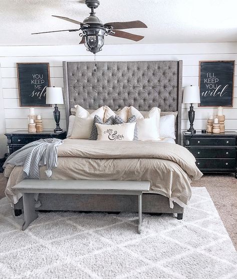 In the master we did a shiplap wall behind the bed and painted the rest of the walls Revere Pewter by Benjamin Moore #shiplap #bedroom #farmhosue #farmhouse Master Bedrooms Decor With High Headboard, Bedroom Ideas With Gray Headboard, Gray Tufted Bedroom Ideas, Grey Tufted Bed Bedroom Ideas, High Headboard Decor Ideas, Gray Bed Frame Bedroom Ideas, High Headboard Beds, Tufted Bedroom, Grey Bed