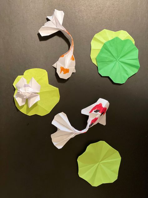 Just finished creating these Origami Koi fishes, water lily & lily pads. Thinking of laying these on a canvass frame and brushing the canvass with black oil color paint for background. Lily Pad Paper Craft, Lily Pad Origami, Paper Lily Pad, Paper Koi Fish, Paper Water Lily, Lily Pad Drawing, Fish Origami, Fish Paper Craft, Origami Koi Fish