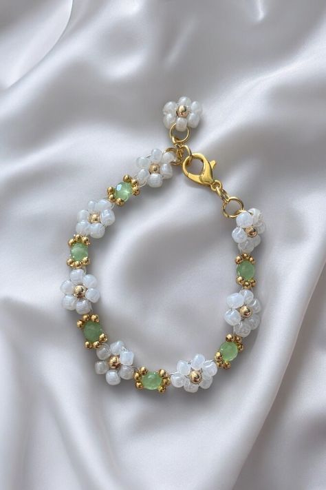 Introducing the exquisite 'Secret Garden' bracelet. This stunning piece of jewellery is designed to complement your outfit with a touch of sophistication. Its beautiful light green color is reminiscent of the natural beauty found in secret gardens. Crafted with attention to detail, this bracelet exudes elegance and style. Its delicate design makes it perfect for both casual and formal occasions, adding a touch of glamour to your look. The 'Secret Garden' e is made from high-quality materials tha Secret Garden Design, Diy Jewelry Set, Braided Bracelet Diy, Green Bracelet, Daisy Bracelet, Bracelets Design, Secret Gardens, Handmade Fashion Jewelry, Bracelet Design