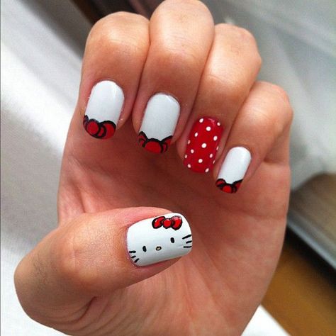 Peek a boo, I see a red ribbon, who is it? It’s Hello Kitty! A very cute and candid nail art design incorporating red and white shades. A red nail is further highlighted with adorable dots of white. Hello Kitty Nail Art, Kitty Nail Art, Hello Kitty Nails Art, Hello Kitty Nail, Kitty Nail, Kitty Nails, Hello Kitty Nails, Cat Nails, Trendy Nail Art