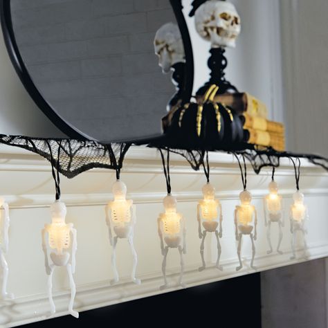 Get this 10ct. Skeleton Icon LED String Lights by Ashland® at Michaels. This battery-operated string of white skeletons is the perfect way to add an eerie glow to Halloween wreaths, garlands and other décor accents. Bring spooky fun to your indoor space with these skeleton string lights. This battery-operated string of white skeletons is the perfect way to add an eerie glow to Halloween wreaths, garlands and other décor accents. Details: White skeletons with black wire 6 ft. (1.8 m) lighted leng Halloween String Lights, Halloween Bathroom, Halloween Wreaths, Halloween Lights, Led String Lights, Battery Operated, String Lights, 8 M, Bathroom Lighting