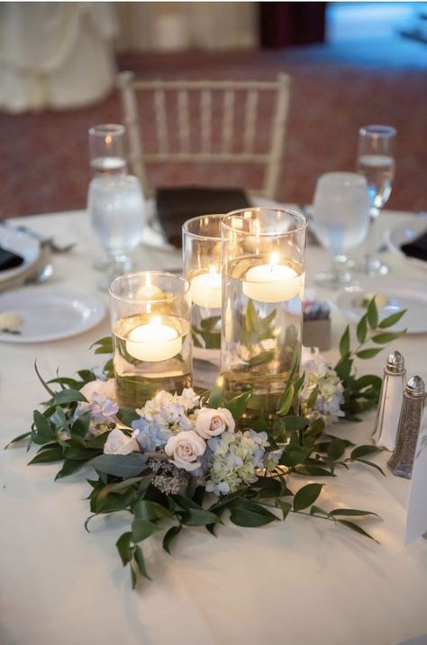 Floating candle wedding centerpiece with greenery and flowers by Eden Events Centerpiece With Greenery, Wedding Centerpeices, Floating Candle Centerpieces Wedding, Round Wedding Tables, Floating Candles Wedding, Candle Table Centerpieces, Winter Wedding Centerpieces, Floating Candle Centerpieces, Blue Centerpieces