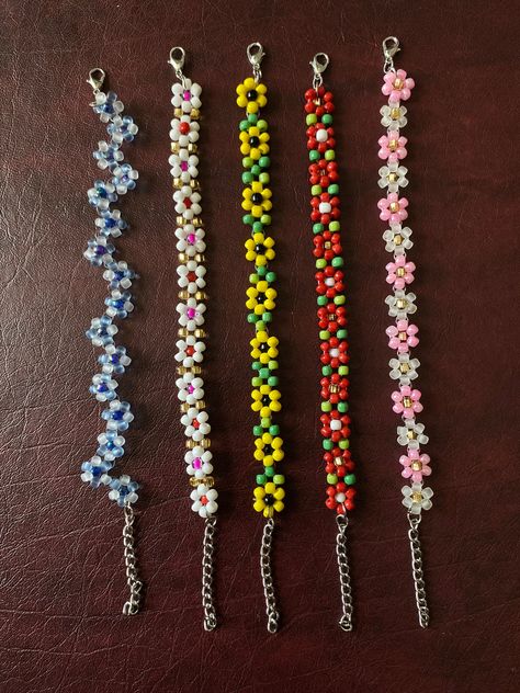 Colorful Seed Bead Bracelet Dainty Beaded Flowers Bracelets Tiny colorful seed beads make up this delicate flower bracelet. Great for layering with other bracelets Choose your length for the perfect fit. Includes a lobster clasp and 1.5 inch extension chain.  *Some colors may be fade over time after being exposed to water. Comes in various different sizes or just order your favorite color and size and we will make it especially for you. Add to that our asortments of beautiful array of colored beaded barefoot sandals excellent for the beach. Anklets, necklace, and bracelets, that skillfully made with love.  Buy as singles or as a set.  Used as a sentiment for your love ones, him and hers bracelets, personalized names, zodiac signs. Great for any gifts ideas. Islandgirls Summer Sassy jewelry Bracelets Ideas For Summer, Cute Tiny Bead Bracelet Ideas, Anklet Seed Bead, Seed Bead Jewelry Ideas Summer, Beaded Bracelets Seed Beads, Seed Bead Creations, Seed Bead Bracelet Sets, Seed Bead Bracelets Flower, Simple Seed Bead Bracelets