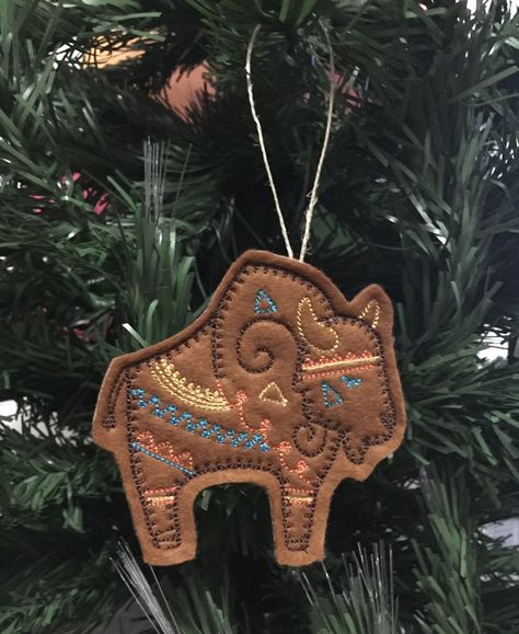 This Felt Southwest Buffao Ornament can be used as a Christmas Ornament or in your decor at any time of the year. This colorful Southwestern Bison design is embroidered on Dark Tan felt. For more Southwest Ornaments click here: https://etsy.me/2m7jS8Z UNBREAKABLE - Safer than glass ornaments around children and pets. However, they are a choking hazard. Each item will have slight differences as they are made by me, one at a time. Native American Christmas Ornaments, Southwest Christmas Decor, Southwestern Christmas Ornaments, Southwest Christmas, Buffalo Bison, Folk Art Flowers, Country Christmas Decorations, Native American Crafts, Cowboy Christmas