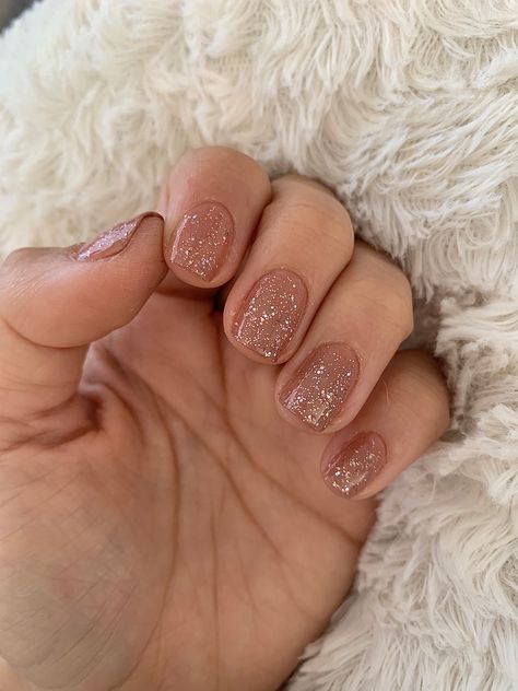 Nail Polish with nude tones and glitter Bridesmaid Nails Glitter, Natural Nail Color With Glitter, Neutral Nail With Glitter, Glitter Nails Neutral, Blush Sparkle Nails, Nude Holiday Nails Short, Sparkly Tan Nails, Short Square Nails Sparkle, Neutral Glitter Nails Acrylic