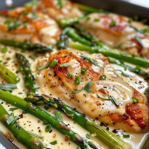 If you’re yearning for a meal that’s quick enough for a busy weekday yet has all the trappings of a leisurely Sunday dinner, then this Caesar Chicken with Asparagus recipe is your answer. It’s a sophisticated twist on the classic Caesar salad, transforming it into a warm, inviting main course that's sure to impress. This dish marries the creamy, tangy flavors of Caesar dressing with juicy chicken and crisp asparagus, creating a symphony of flavors in one pan—and who doesn’t love minimal ... Cesar Chicken With Asparagus, Parmesan Caesar Chicken, Caesar Chicken And Asparagus, Caesar Chicken With Asparagus, Chicken Cesar Cutlet, Chicken Caesar Casserole, Chicken With Asparagus Recipes, Chicken And Asparagus Recipes, Cesar Chicken