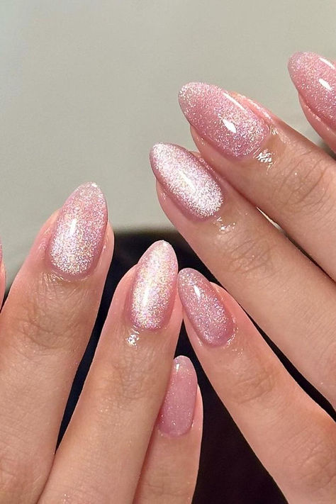 Radiant Elegance: Shimmering Pink Cat Eye Almond Nails exuding sophistication and charm 💖✨ // Photo Credit: Instagram @pallyynails Pink Sparkle Almond Acrylic Nails, Creamy Purple Nails, All Pink Glitter Nails, Pink Nails Magnetic, Light Pink Magnetic Nails, Light Pink Velvet Nails, Nails Pink Cat Eye, Magnetic Almond Nails, Magnet Nails Pink