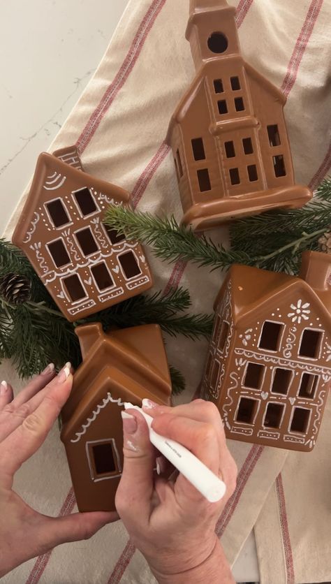 Turn a Ceramic Village into a Gingerbread Village. Revamp a plain ceramic Christmas village into a festive delight using spray paint, a white paint pen, and puffy paint. Gingerbread Painting Ideas, Gingerbread Village Diy, Painting Gingerbread Houses, Ceramic Gingerbread House Diy, Painted Gingerbread Houses, Gingerbread Crafts Diy, Gingerbread Christmas Village, White Gingerbread House, Ceramic Christmas Village