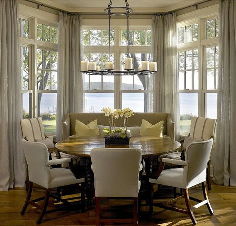 Gorgeous round dining table in front of a bay window with an amazing water view! Wonderful design by Hickman and Associates - round dining tables - monochromatic color scheme - casual dining room Dining Room Bay Window, Bay Window Decorating Ideas, Bay Window Dining, Kitchen Bay Window, Breakfast Nook Table, Nook Table, Casual Dining Rooms, Curtains Window, New Interior Design