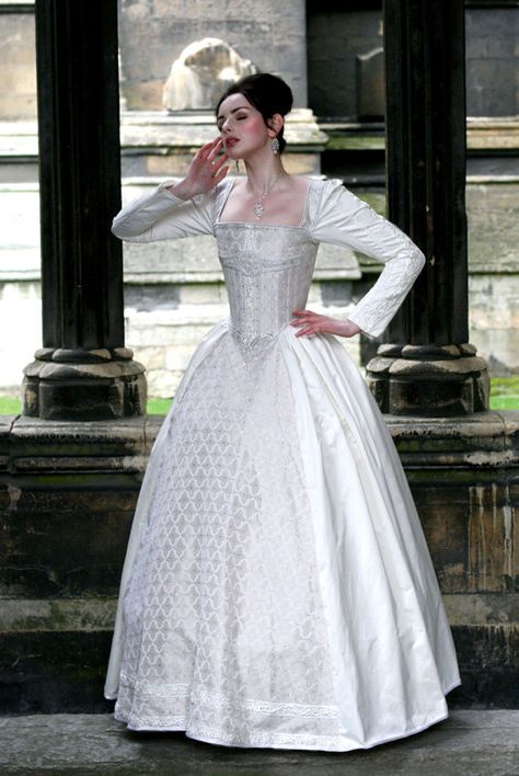 This gown is truly one of a kind. It comes to you in pure while silk, with a cream brocade bodice and skirt front panel encrusted with 3500 tiny Elizabethan Gown, Sewing Costumes, Theatrical Costumes, Costume Department, Period Fashion, Tudor Fashion, Making A Wedding Dress, Paper Dresses, Historical Dress