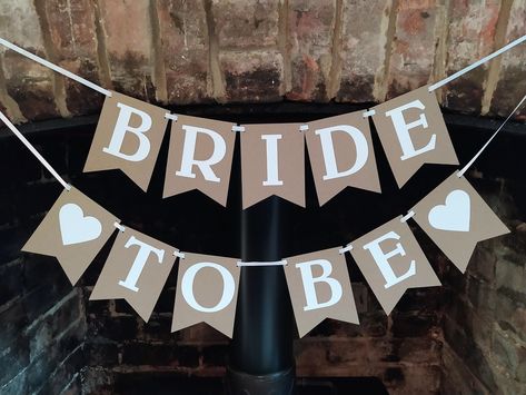 "Bride to be Banner A lovely quality decoration for your hen party, bridal shower with a choice of pink or white heart motif. Handmade by me from quality 280gsm 100% recycled card stock and strung with a white satin ribbon. Each flag measures 3.75\" (9.5cms) x 5\" (12.7cms) The white lettering is cut from 300gsm quality card stock. You will receive two banners as in the listing photos. Your banner will arrive already threaded with the satin ribbon ready for hanging anywhere in your home or venue Bride To Be Banner Diy, Bride To Be Party Decoration Ideas, Bride To Be Decoration Ideas, Bride To Be Decorations, Bride To Be Banner, Hen Party Decorations, Jungle Party Decorations, Events Business, Bridal Shower Banner