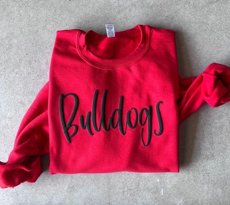 Stand out with this 3d puff vinyl sweatshirt! You can customize it to your team! Perfect for game day -Unisex sizing - Design is puff vinyl - The longer the text, the smaller the font will be. We offer mock ups if requested. -Text will be on 1 line. If you are wanting 2 lines there will be a $6 charge. Please message me before ordering Washing instructions for puff vinyl: Machine wash warm or cold on gentle cycle. Use mild detergent. Wash inside out, Do not use bleach or dry clean. Tumble dry on normal setting Any questions, please message before ordering :) Puffy Vinyl Sweatshirt, Puff Vinyl Shirts, Puffy Vinyl Shirt Ideas, Puff Vinyl Sweatshirt, Puff Vinyl Shirt Ideas, 3d Puff Vinyl, Cricut Pins, Spirit Wear Designs, Puff Vinyl