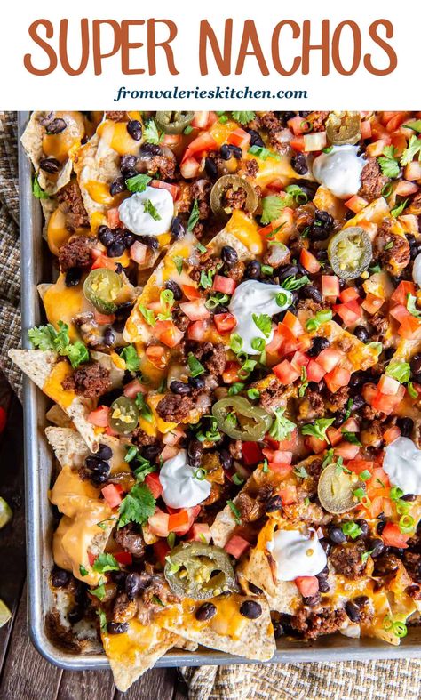 These sheet pan Super Nachos are loaded with ground beef, black beans, homemade nacho cheese sauce, and plenty of freshly shreddded cheese. Just pile on your favorite toppings and dig in! Best Loaded Nachos Recipe, Nachos With Rotisserie Chicken, Seasoning For Nacho Meat, Loaded Sheet Pan Nachos, Grilled Nachos On Grill, Nacho Platter Recipes, Nacho Plate Ideas, Fully Loaded Nachos, Nacho Dinner Recipes