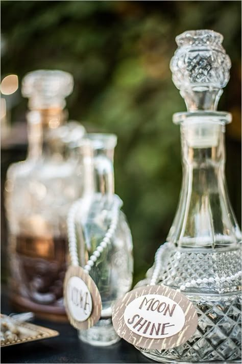 label vintage bottles #roaring20wedding #cocktailstation #weddingchicks http://www.weddingchicks.com/2014/01/02/easy-roaring-20s-wedding-ideas/ Vintage Bottles Wedding, Art Deco Wedding Inspiration, Roaring 20s Wedding, 20s Wedding, Roaring 20s Party, Gatsby Theme, 1920s Wedding, Wedding Bottles, Vintage Wedding Theme