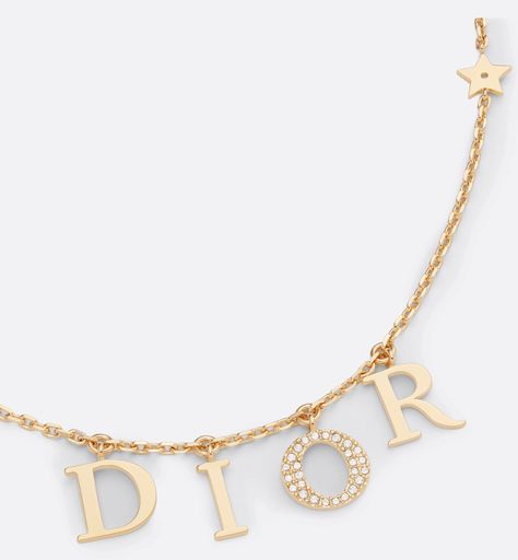 The Dio(r)evolution necklace is both elegant and timeless. The 'DIOR' letters are suspended on a gold-finish metal chain, and the letter 'O' is in a pavé of white crystals to add shimmer to the neck. The effortless style can be worn with other creations from the Dio(r)evolution line.. Dior Letter Necklace, Dior Necklace Gold, Dior Jewelry Aesthetic, Sweet 16 Jewelry, Dior Necklace, Pretty Jewelry Necklaces, Dior Jewelry, White Crystals, Expensive Jewelry