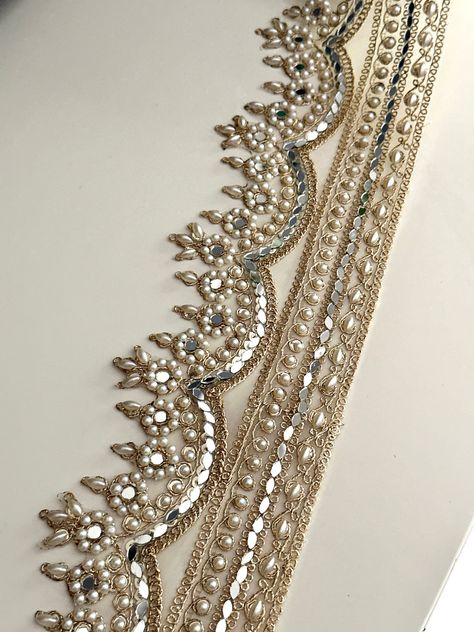 ✦This 8.5cm light gold scalloped zari border trim features elegant mirrors, sequins, and pearl embellishments,  ✦Perfect for enhancing wedding dresses, saris, and craft projects. Ideal for adding a luxurious touch to bridal wear and traditional outfits. Uses: Perfect for wedding dresses, Indian saris, waistbands, chokers, home décor, and craft projects. Material: Made from high-quality Indian zari, adorned with mirrors, sequins, and pearl embellishments on a fabric base 8.5 cm wide PLEASE FOLLOW Embellishments Fashion, Mirror Sequin, Scalloped Mirror, Embellished Wedding Dress, Zardosi Embroidery, Simple Hand Embroidery Patterns, Hand Beaded Embroidery, For Wedding Dresses, Dress Trims