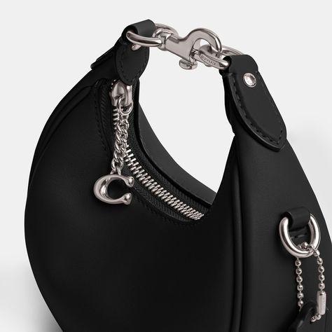 Find COACH Jonie Bag on Editorialist. The Coach Jonie Bag is crafted from soft glovetanned leather and features a rounded crescent silhouette. The bag includes a secure zip-top closure with a C hardware detail, a top handle, and a detachable leather crossbody strap. The bag can be carried by hand, worn as a wristlet, or worn crossbody. Black Coach Purse, Purse Ideas, Soft Leather Handbags, Fashion Moodboard, Coach Handbag, Hobo Style, Designer Crossbody, Mood Board Fashion, Black Gift