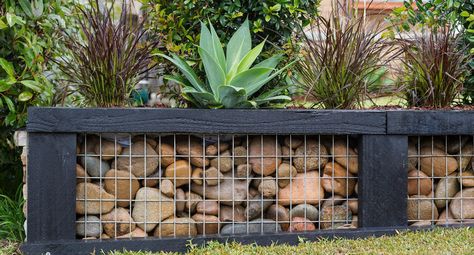 Replace a damaged old garden wall with this rock-steady option! Rock And Metal Retaining Wall, Rock And Wire Retaining Walls, Wood And Stone Retaining Wall, Rock Wire Fence, Garden Wall Ideas Brick And Fence, Retaing Walls Landscape, Garden Landscaping Design Ideas, Gabion Walls, Fire Circle