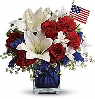 America the Beautiful by Teleflora  A patriotic pick to send a brave veteran, decorate your Fourth of July picnic, or celebrate Memorial Day. Lush red, white and blue flowers are presented in a deep blue glass cube vase along with an American flag.