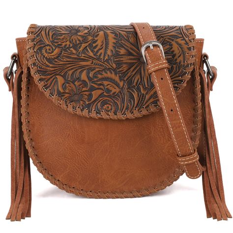 PRICES MAY VARY. Inspired by the classic Acanthus, a symbol of life and vitality in ancient Greece, our crossbody bag is the designer's creation. Leather tassel on both sides and whipstitch details give a rebellious touch to this western purse's slouchy look. Top zipper closure. Magnetic button closure flap.Adjustable crossbody strap. The inside of the bag includes a zippered pocket and 2 open pockets.Size: 8.5" x 3.5" x 8.5" (Drop 24") Montana West combines the best of traditional western eleme Western Bags Purses, Saddle Purse, Western Tote Bags, Montana West Handbags, Modern Handbag, Western Bag, Modern Cowgirl, Western Purses, Western Saddle