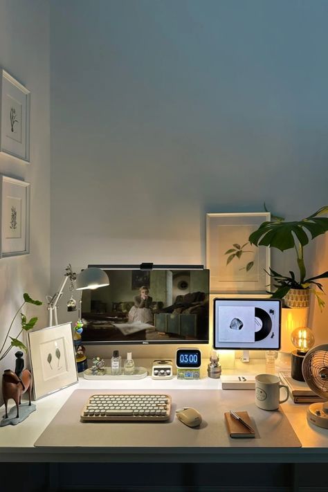 A minimalist home office setup with a dual monitor, mechanical keyboard, ambient lighting, and small decor like plants and art. Ideal for productive work sessions. Minimal Desk Lamp, Minimalist Desk Setup, Desk Arrangement, Desk Arrangements, Home Office Designs, Minimal Desk, Minimalist Home Office, Cozy Desk, Clean Desk