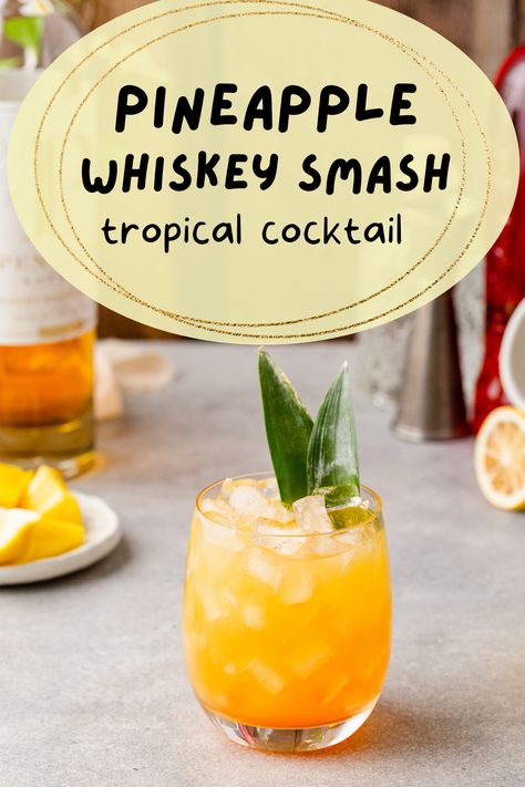 Side view of pineapple bourbon smash cocktail with pineapple frond garnish and the overlay text "pineapple whiskey smash tropical cocktail". Pineapple Whiskey Sour, Pineapple Whiskey Drinks, Pineapple Bourbon Cocktail, Hawaiian Brunch, November Meals, Whiskey Smash, Pitcher Cocktails, Summertime Cocktail, Bourbon Smash