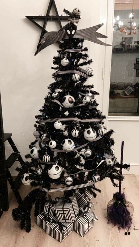 a black Halloween tree decorated with striped and Jack Skellington ornaments, striped ribbon and black brooms White Christmas Tree Halloween, Fake Christmas Tree Ideas, White Halloween Tree, Halloween Christmas Tree Ideas, Jack Skellington Ornaments, Black Halloween Tree, Disney At Home, Halloween Tree Decorations, Black Christmas Decorations