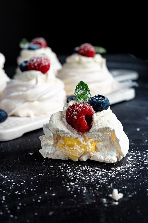 Pavlova is one of the most delicate desserts ever. I love making this berry almond pavlova with lemon curd and I love eating it! Learning an easy pavlova recipe means you can make this impressive dessert whenever the mood hits. Plus it is a bonus that it is a gluten free dessert. If you are looking for a recipe for a dessert with fresh berries or an easy pavlova recipe, this is one to try! Have you ever had pavlova with lemon curd? #pavlova #glutenfree #dessert #eggwhite #berries #lemoncurd Easy Pavlova Recipe, Pavlova With Lemon Curd, Easy Pavlova, Lemon Curd Pavlova, Delicate Desserts, Berry Pavlova, Pavlova Dessert, Impressive Dessert, Meringue Desserts