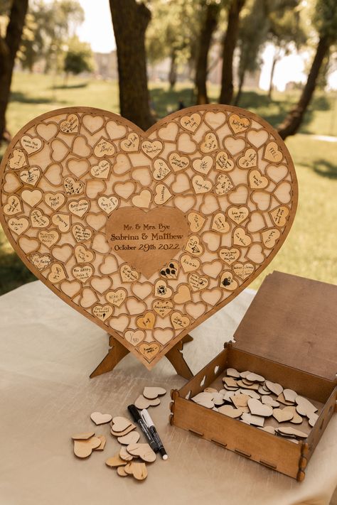 PRODUCT DETAILS Personalized wedding guest book alternative made of wood can become a stylish present and interior decoration. We use only top quality materials and pay attention to all the details.we strive to create a special present for your friends and family. WHAT YOU'LL GET WITH: ♥ Wooden base for inserting Pieces ♥ Pieces regarding your order ♥ As a gift a pen The wooden heart for guest wishes will be accompanied by a wooden plate(not necessary), explaining the guests the purpose of the g Country Wedding Guest Book, Guest Book Wood, Puzzle Guest Book, Wood Guest Book, Alternative Gifts, Personalized Wedding Guest Book, Heart Shaped Frame, Laser Engraved Ideas, Wedding Guest Books