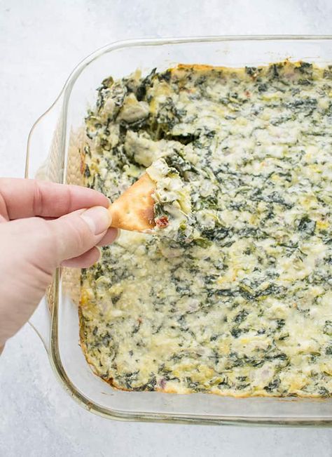 You need this Asiago Spinach and Artichoke Dip in your life! It's a creamy, cheesy hot dip with chunks of artichokes, sautéed red onions and a touch of spicy heat. A delicious, vegetarian appetizer to serve for game day, parties or even dinner! #spinachartichokedip #spinachandartichokediprecipe Spinach Crab Dip, Crab Spinach Dip, Spinach Artichoke Dip Recipe Easy, Spinach Artichoke Dip Easy, Hot Spinach Dip, Dip Recipes Hot, Spinach Artichoke Dip Recipe, Spinach And Artichoke Dip, Hot Crab Dip