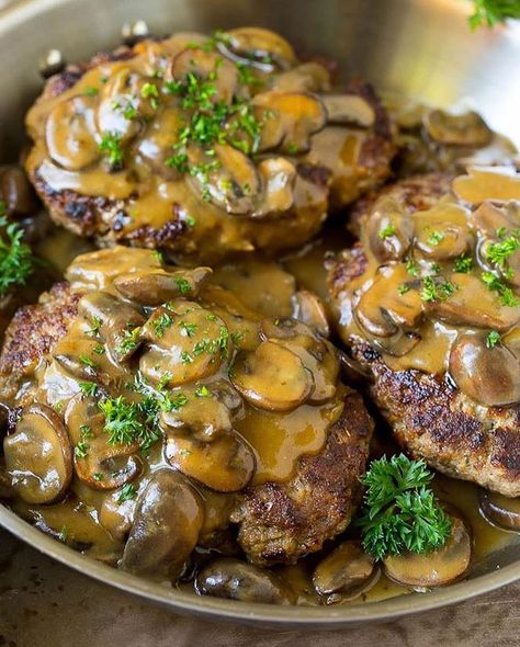 Hamburger Steak with Mushroom Gravy This recipe is seasoned ground beef patties simmered in a savory mushroom sauce. A comfort food classic… Chopped Hamburger Steak, Burger Patty Dinner Ideas, Hamburger With Mushroom Gravy, Hamburger And Mushrooms, Hamburger And Mushroom Recipes, Hamberg Recipes, Burger Patty Meal Ideas, Burger Patty Recipe Beef, Chop Steak Recipe