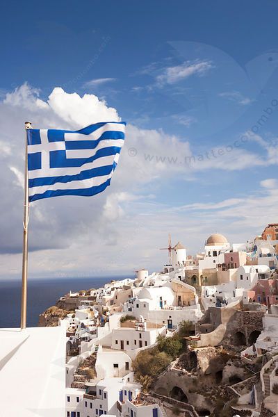 Greek national flag waving, in the village of Oia, Santorini, Greece Greece Flag Aesthetic, Greek Flag Aesthetic, Greece Wallpaper, Oia Santorini Greece, Greece Flag, Greece Trip, Greek Flag, Greece Santorini, Travel Collage