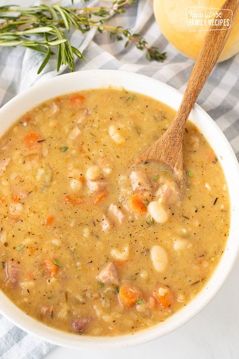 Ham and Bean Soup will warm your soul and belly this season. Hearty chunks of ham, buttery beans and veggies in a savory broth makes this a comforting winter supper. #soup #ham #leftoverham #beans #heartysoup #hamandbeansoup #beansoup #hamsoup #wintersoup #fallsoup #healthysoup #leftovers #hotsoup #navybeans #hambone #souprecipes #greatnorthernbeans #whitebeansoup Recipes With Ham Broth, Ham Bone Soup Recipes, Soup Ham, White Beans And Ham, Healthy Ham, Ham Soup Recipes, Ham Bone Soup, Ham And Bean, 15 Bean Soup