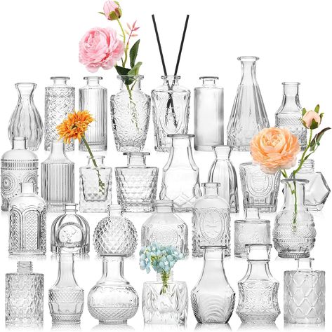 STURDY AND THICK GLASS---30 pcs bulk bud vases are made of high quality thick and strong glass,which are durable and not easy to break. The bottom is non-slip and the center of gravity is stable. These petite little vases were perfect for wedding tables and also be reused for any other table decor or home decor. You can also add some dried flowers or aromatherapy sticks to the vase. ALL UNIQUE DESIGNS AND DIFFERENT SHAPES AND SIZES. Shapes and heights (3-5.5 inches) Hiasan Perkahwinan, Vasos Vintage, Vases For Centerpieces, Wedding Table Decorations Centerpieces, Glass Vases Centerpieces, Vases For Flowers, Small Vases, Tafel Decor, Small Glass Vases