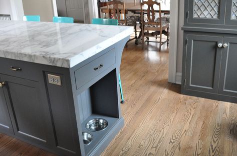 Stylish and thoughtful kitchen design charcoal gray kitchen cabinets with nickel hardware, and Lyon Stool with Steel Back in turquoise blue paired with a gray kitchen island with carrara marble countertops and built in pet food bowls. Pet Food Cabinet, Charcoal Gray Kitchen Cabinets, Island Storage, Kitchen Island Storage, Grey Kitchen Island, Серая Кухня, Dog Kitchen, White Kitchen Island, Mobil Home