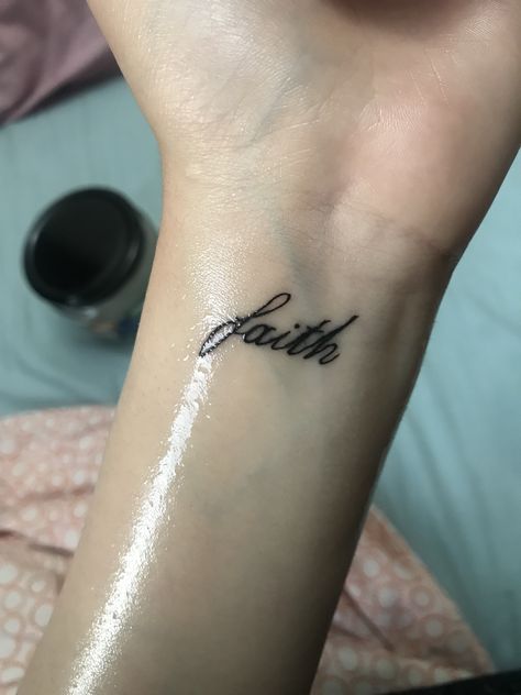 Tattoo Faith Symbol, Faith Tattoo Hand, Faith In Cursive Tattoo, Walk By Faith Tattoo Arm, Faith Wrist Tattoos For Women, Faith Tattoo Wrist, Small Tattoos For Women On Wrist, Wrist Word Tattoos, Tattoos For Guys Wrist