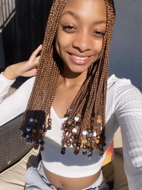 Short Brown Knotless Braids With Beads, Brown Braids With Brown Beads, Ginger Twist With Beads, Brown Braids For Black Women With Beads, Brown And Blonde Box Braids With Beads, Brown Fulani Braids With Beads, Long Brown Braids With Beads, Light Brown Braids With Beads, Brown Short Braids With Beads