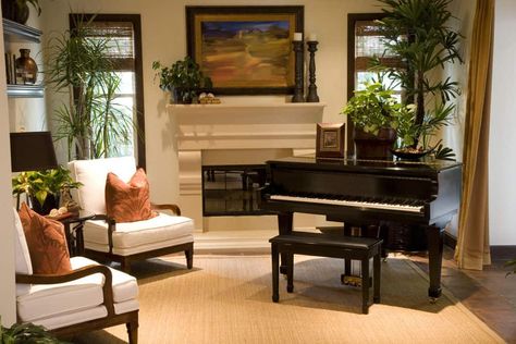 Living room with two white accent chairs, fireplace, light beige carpeting and black piano. Piano Room Design, Grand Piano Living Room, Grand Piano Room, Piano Room Decor, Piano Living Rooms, Piano Lounge, Home Music Rooms, Piano Decor, Baby Grand Piano