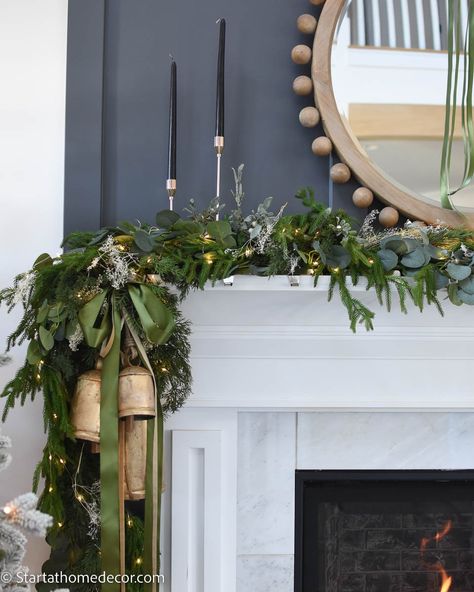 Mantle Holiday Decorating Ideas, Christmas Mantle Decor With Bells, Mantle Christmas Garland Ideas, Mantle Garland With Ribbon, Bells On Mantle Christmas, Decorate Pendant Lights For Christmas, Christmas Mantle With Bells, Christmas Mantle Garland Ideas, Fireplace Mantel Christmas Decor Ideas